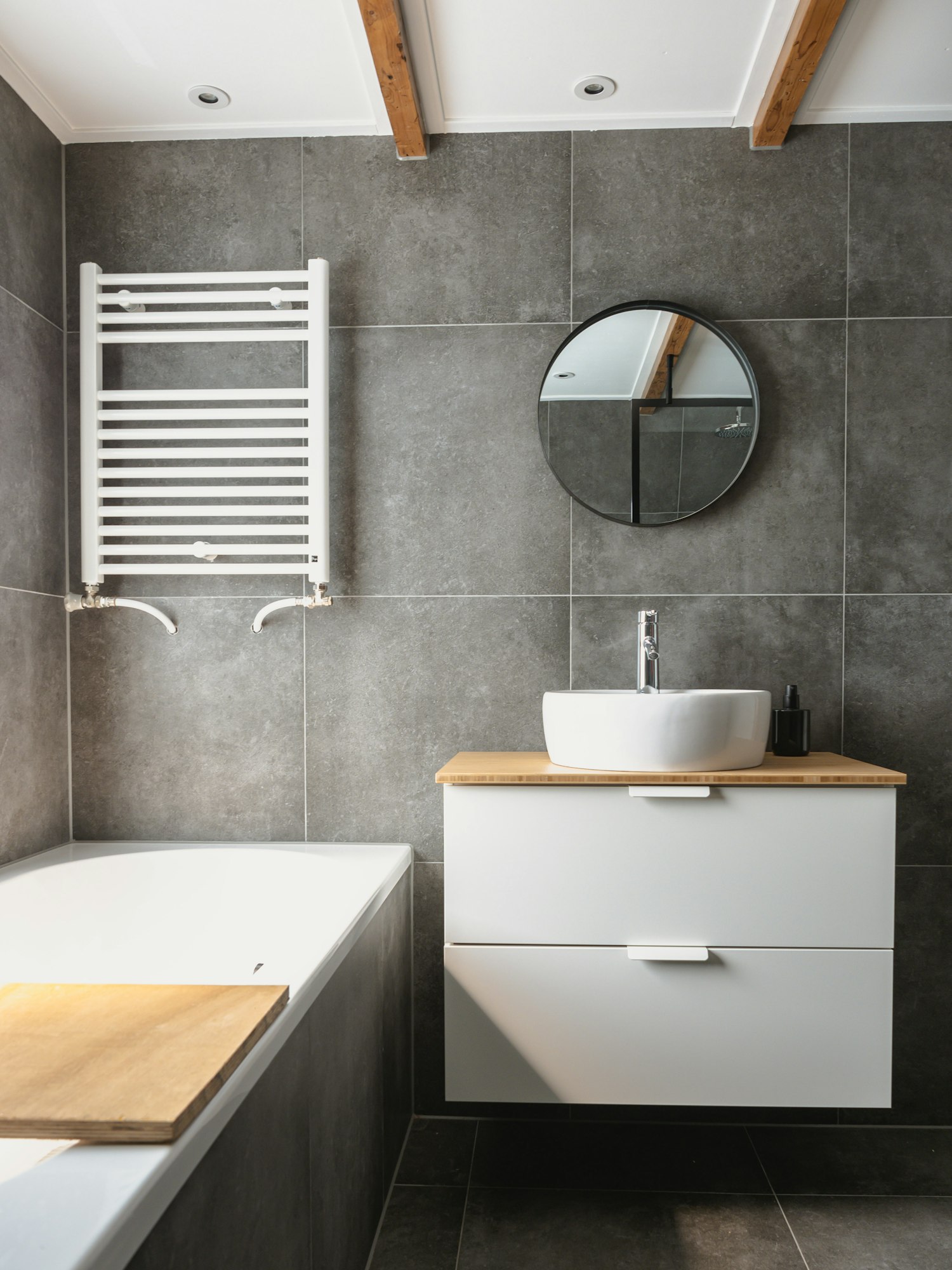 Clean white bathroom with walk-in shower enclosure and calm material palette