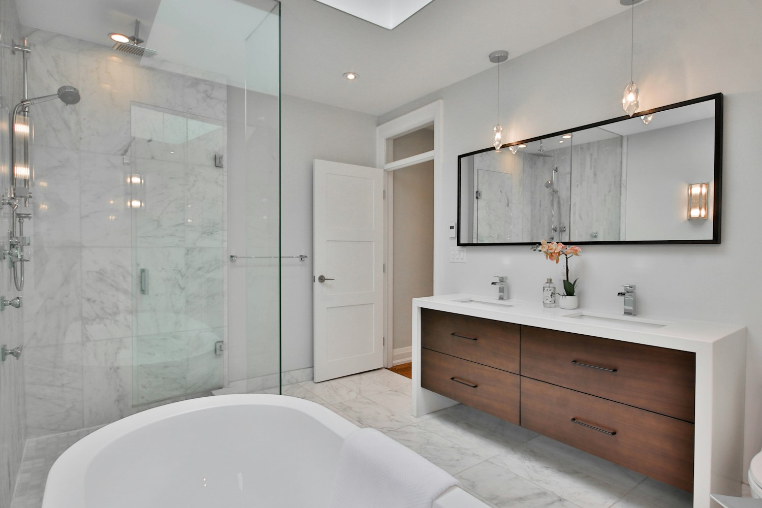 Modern double-vanity bathroom with marble finish — Houston remodel