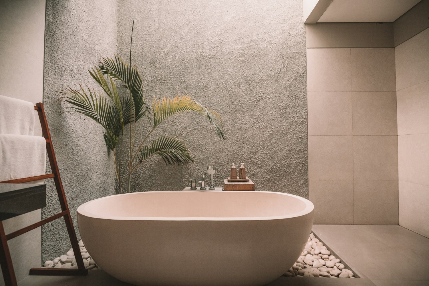 Clean white ceramic bathtub with surrounding tile and calm material palette
