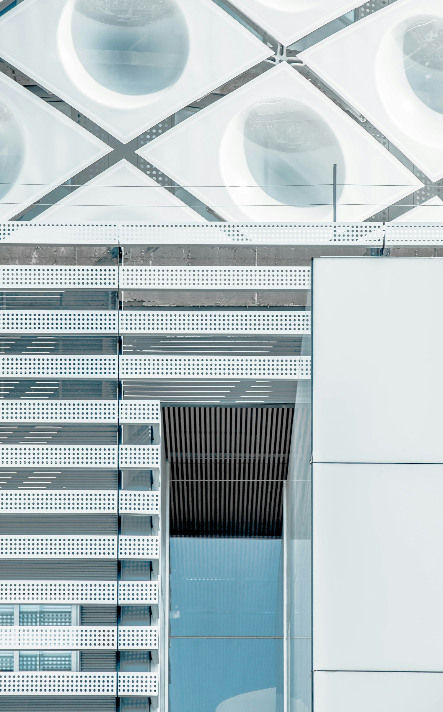 Commercial office building exterior with glass entrance door and geometric facade — architectural detail