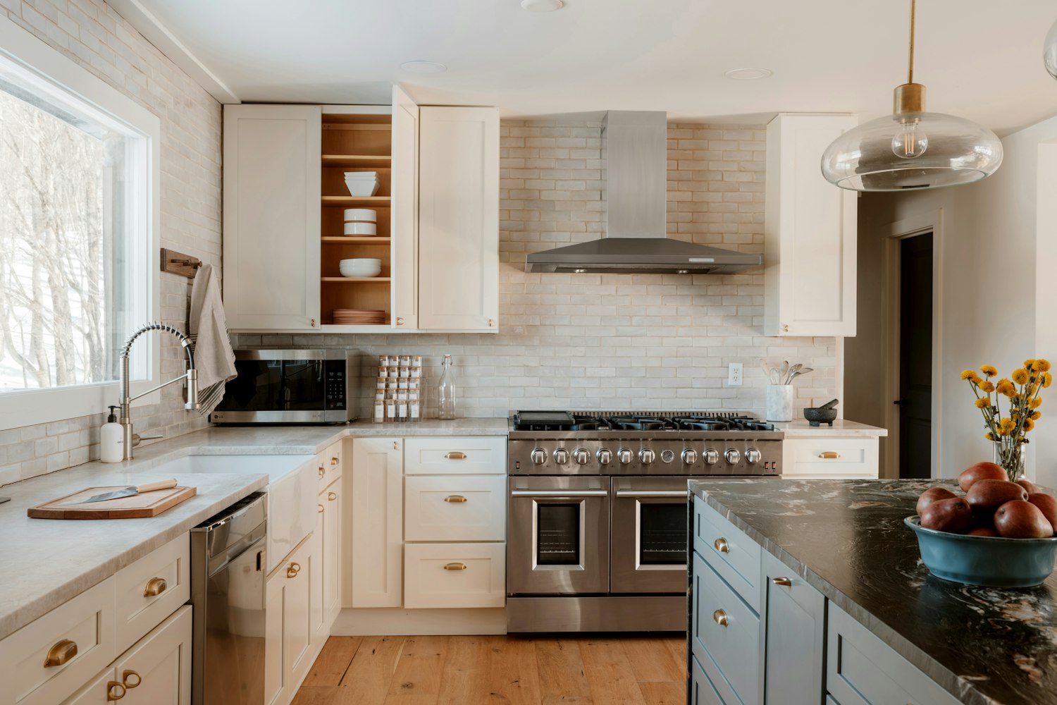 Modern kitchen with green subway tile backsplash and clean cabinet lines
