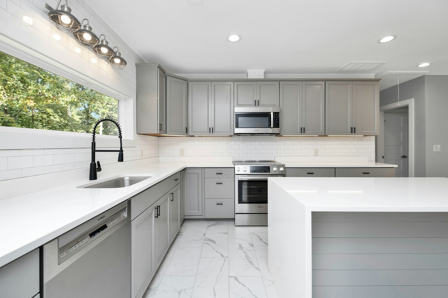 Bright modern kitchen with hard-surface flooring — Houston kitchen remodel